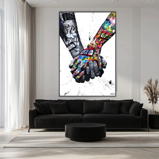 Deux mains entrelacées en street art, contrastes noir et blanc et couleurs vives, ambiance urbaine et message de solidarité.