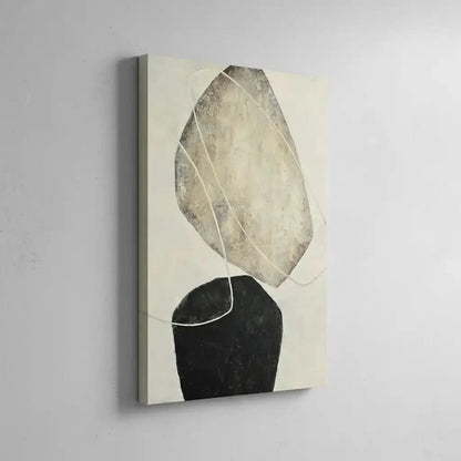 Tableau abstrait avec formes suspendues en tons beige et noir. Style moderne, idéal pour un salon épuré.