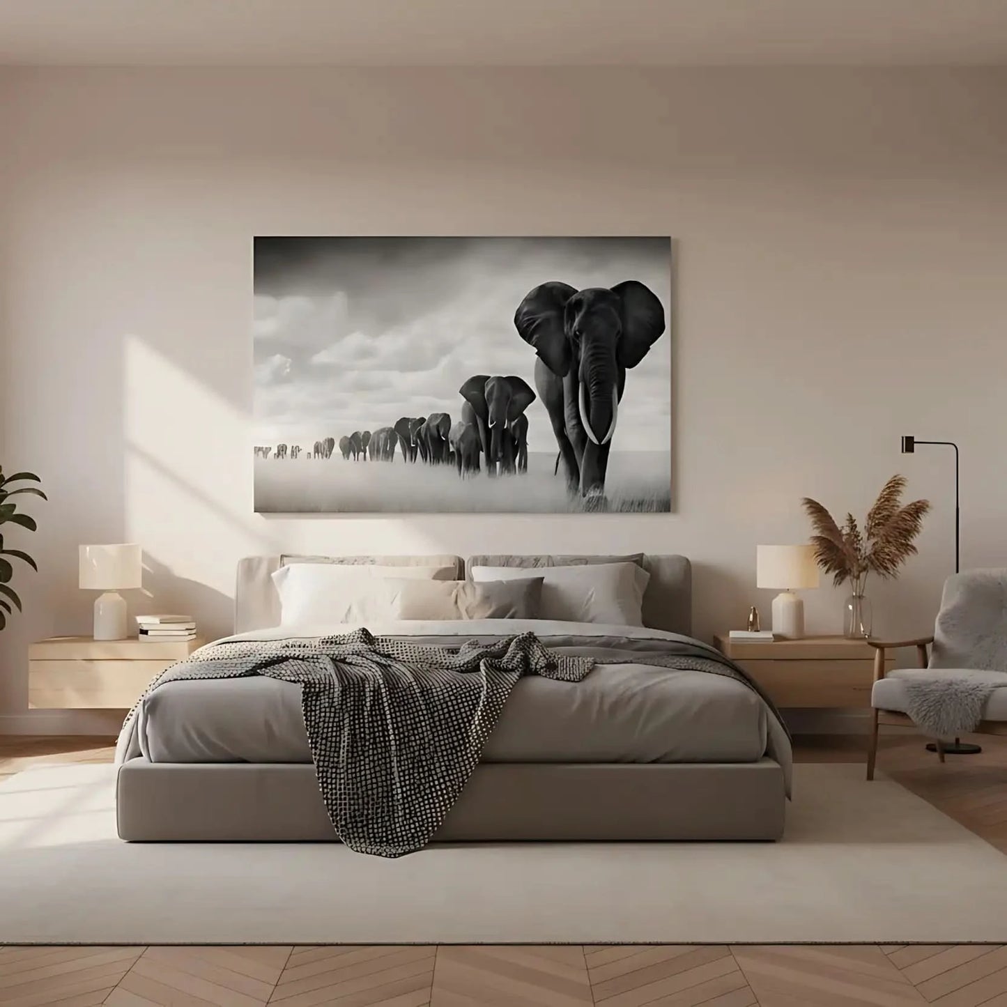 Tableau noir et blanc d'une file d'éléphants avançant dans la savane sous un ciel nuageux, symbole de force et d'unité.