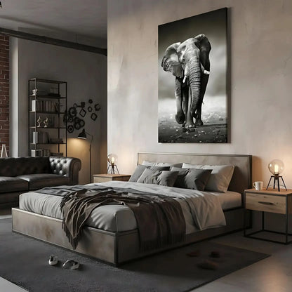 Photo noir et blanc d'un éléphant solitaire marchant sur terrain rocailleux, capturant sa force et sa majesté.